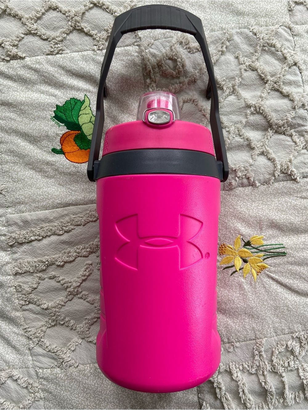 Under armour pink insulated beverage jug with fence hooks holds 64 ounces.